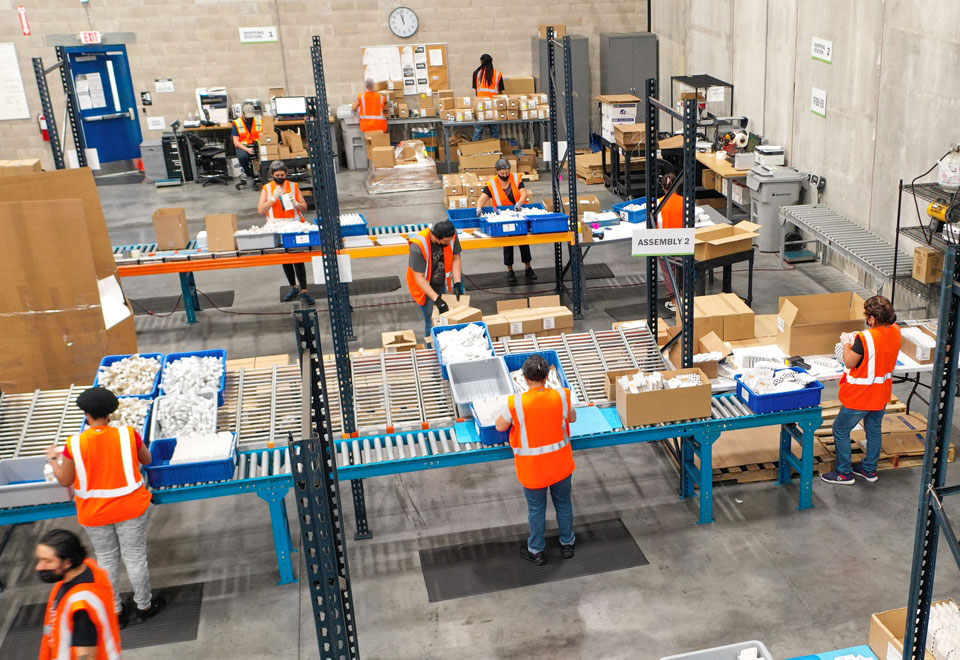 staff assembling products in warehouse